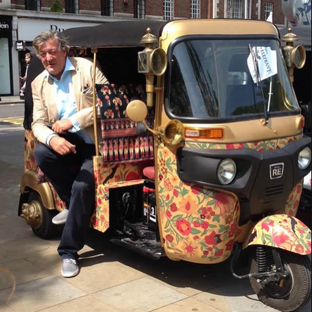 Gold and floral hand-decorated tuk tuk at a London event