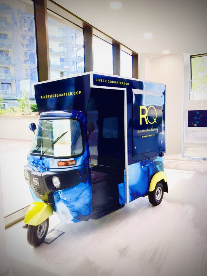 Riverside Quarter branded tuk tuk used indoors for a launch event