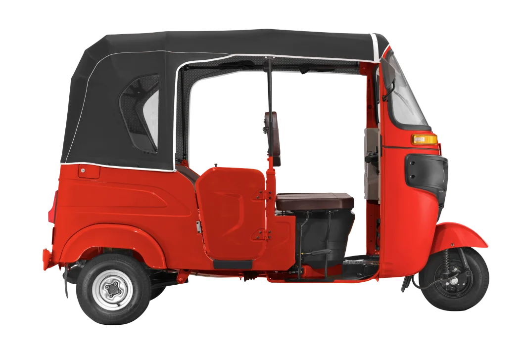 Red Bajaj RE petrol tuk tuk photographed from the front three-quarter angle