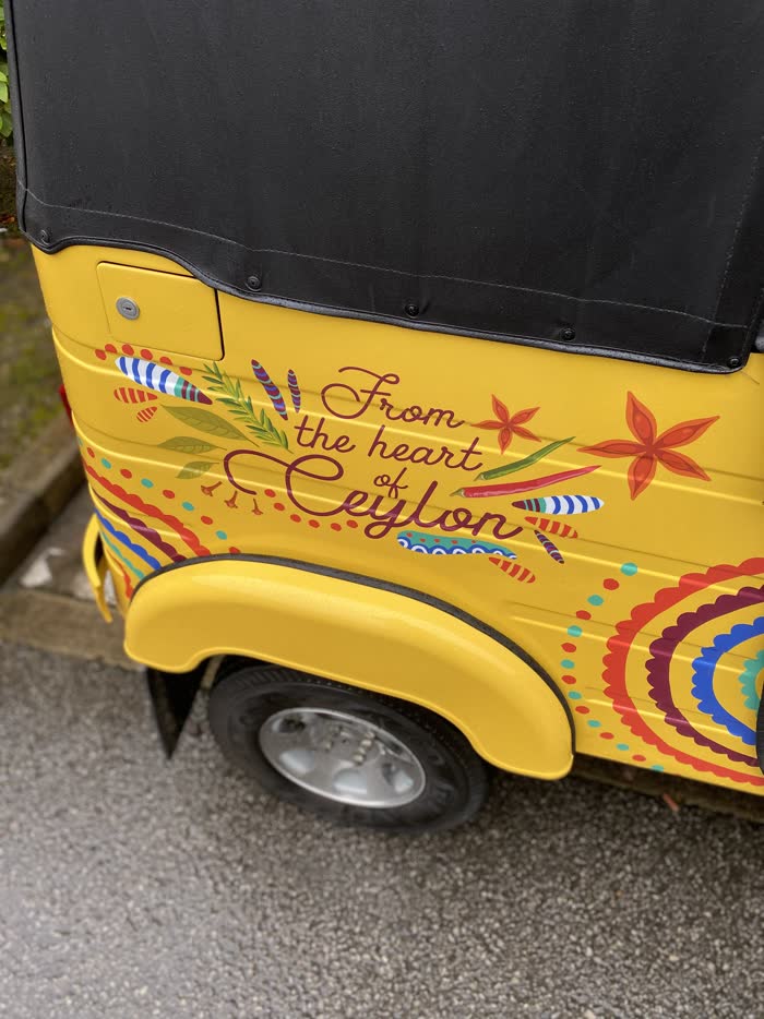 'From the heart of Ceylon' hand-lettered artwork on a yellow tuk tuk