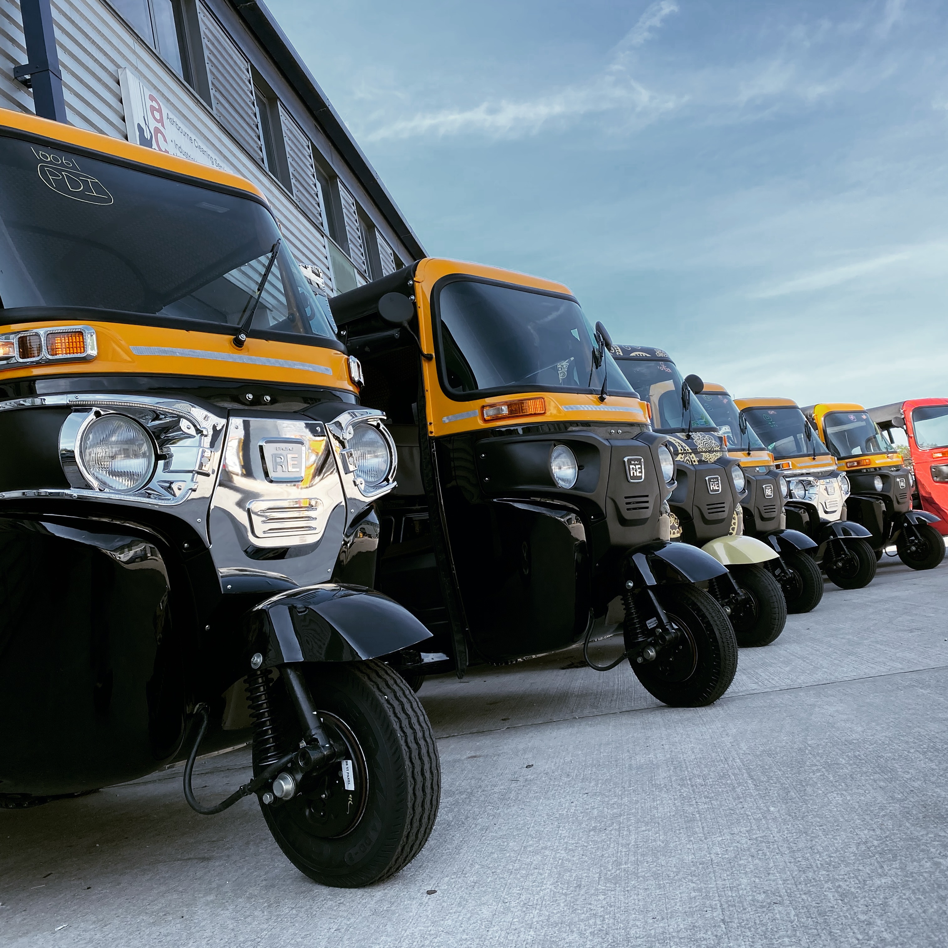 A Bajaj RE 4S, in yellow, ready to go. — Tuk Tuk UK